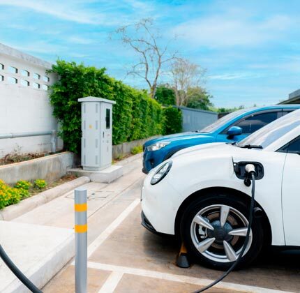 electric cars plugged into am outdoor charging station