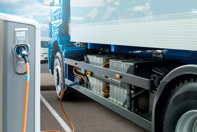 electric commercial truck attached to a charging station